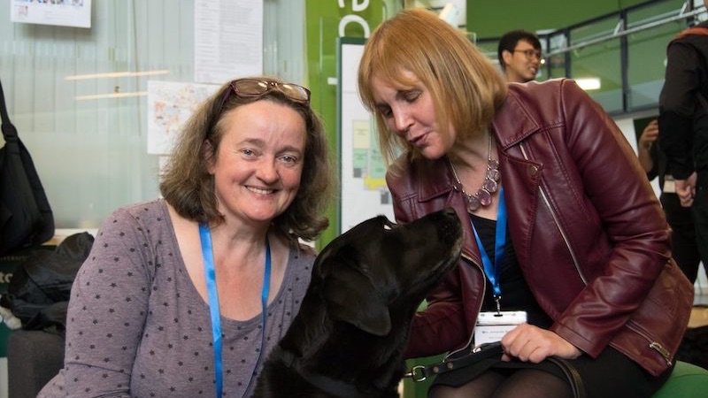 Two woman and a guide dog