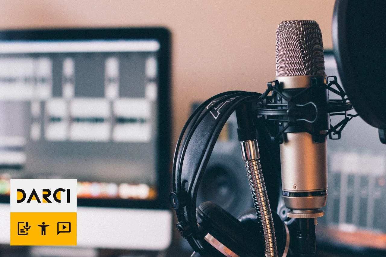 ‘A photo of studio with a computer screen, microphone and headphones.’