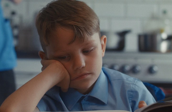 ‘Spines poster. Boy sitting by the table.’