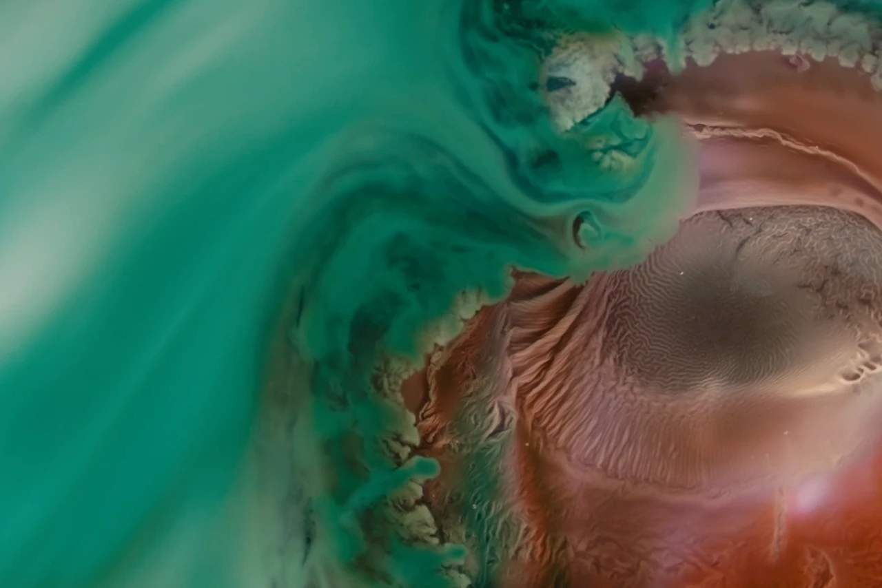 A vibrant abstract swirl of turquoise and coral colors, resembling flowing liquid patterns or marbling art, with intricate textures.