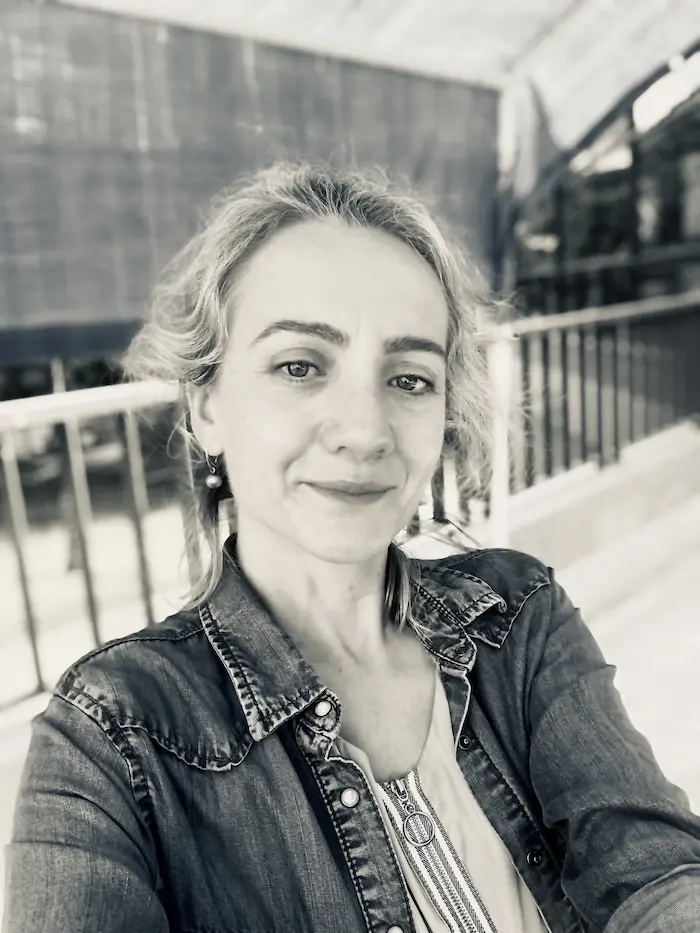 A greyscale photo of Monika in a denim jacket.