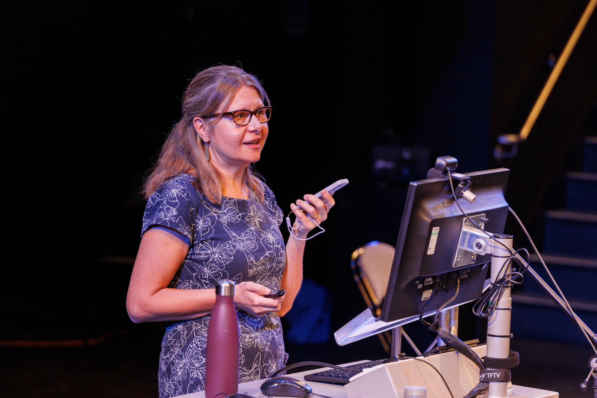 Hannah presenting behind a lectern.