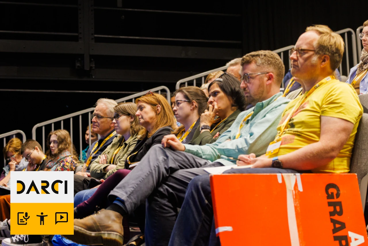 A photo of an audience sitting in the theatre.