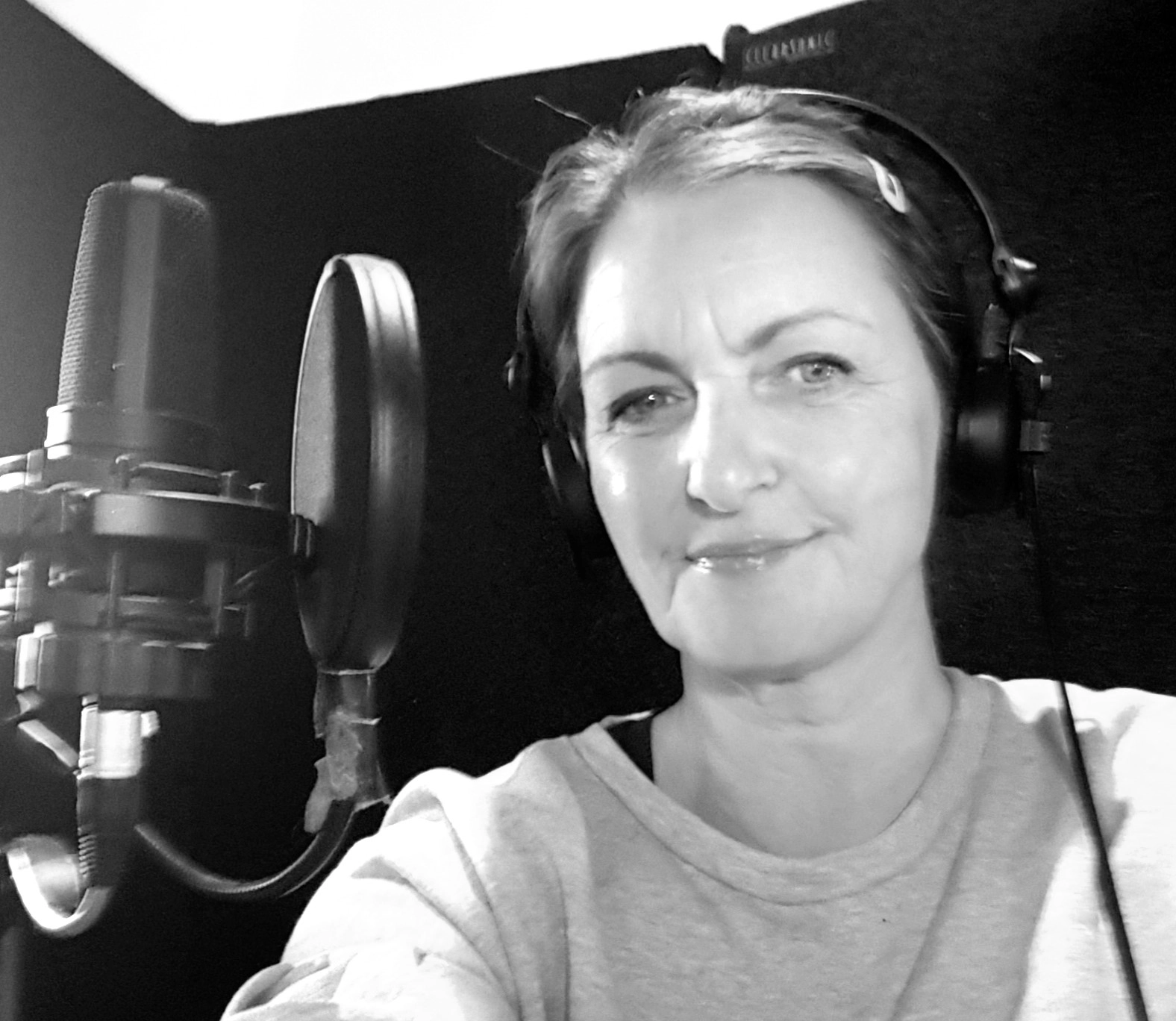 Samuel sits in his chair smiling.